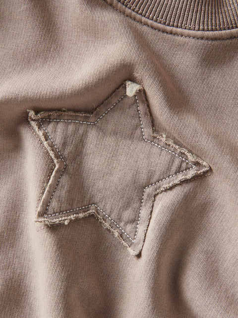 Star-shaped patch on a brown fabric surface