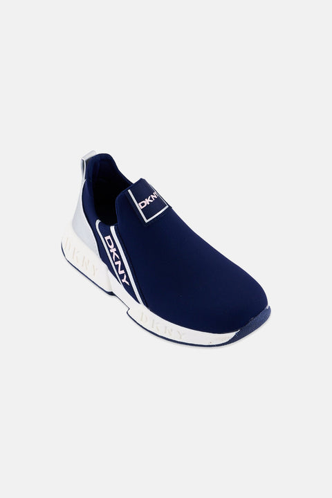 Navy slip-on sneaker with white sole on a light gray background