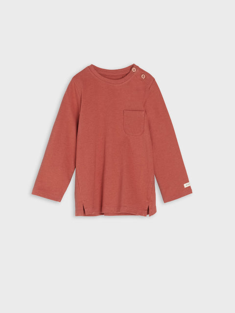 Red long-sleeve shirt with a pocket on a light gray background