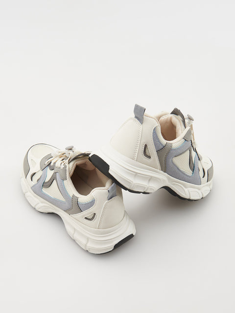 Pair of white and gray sneakers on a light gray background