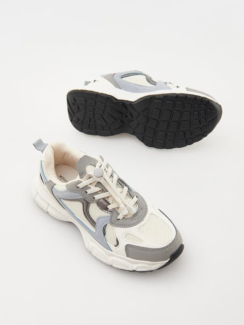 Pair of white, gray, and black sneakers on a light gray background