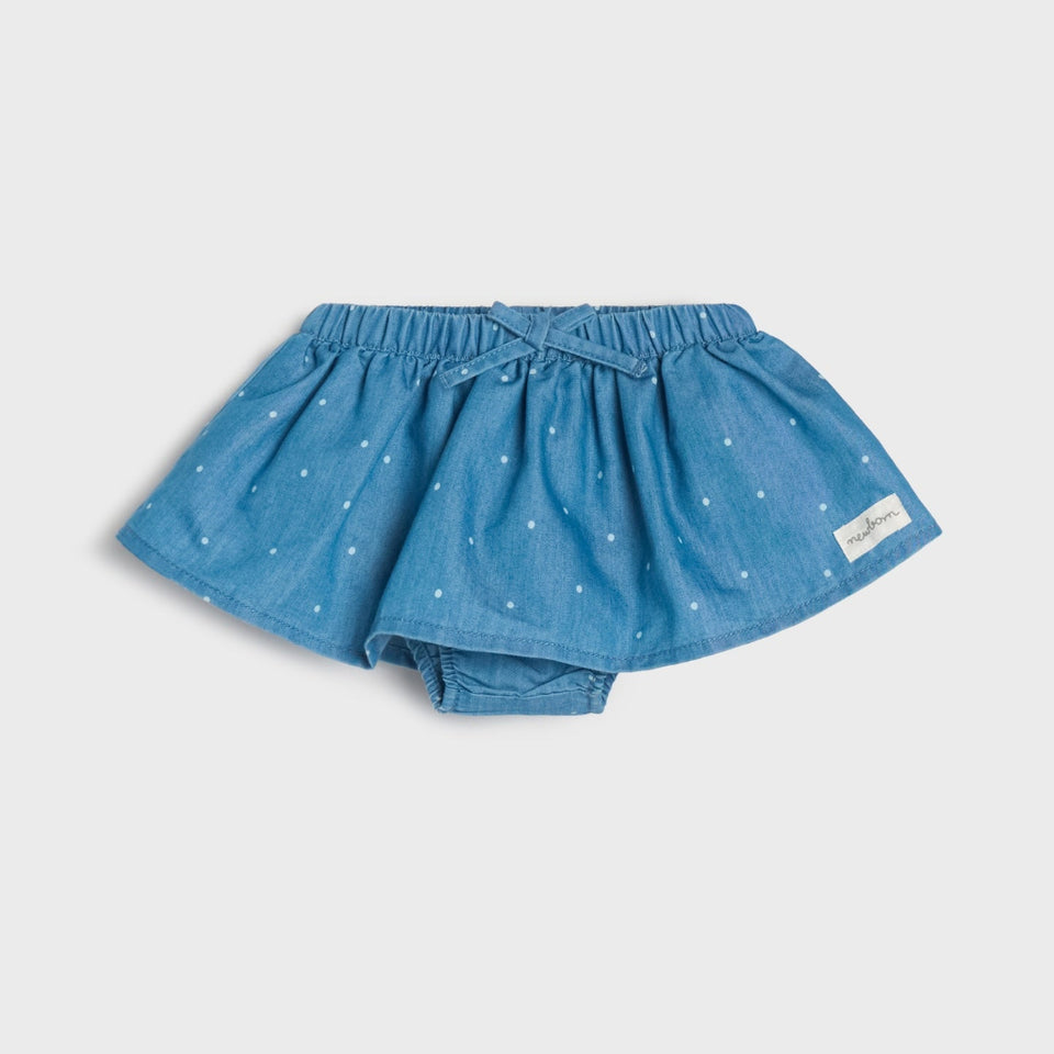 A pair of toddler denim bloomers in a medium blue color, decorated with small white embroidered stars, shown against a light gray background.