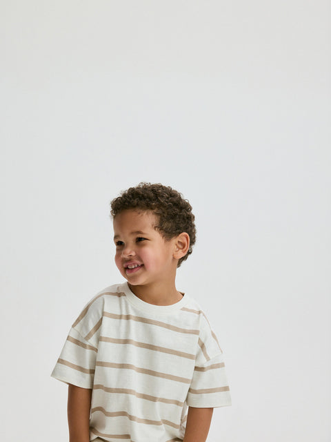 Child wearing a striped shirt against a plain background