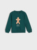 Green sweatshirt with a gingerbread man design on a light gray background