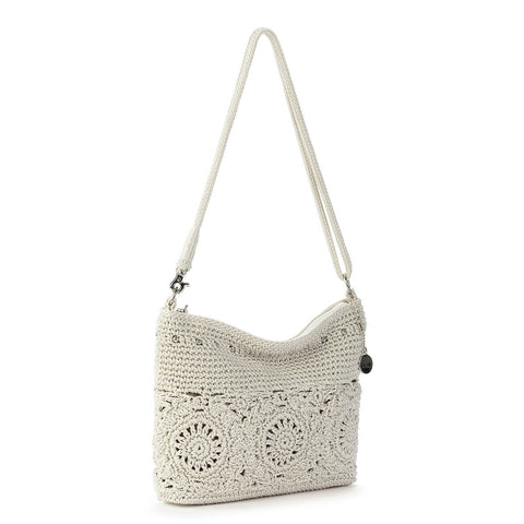 Crocheted handbag with floral patterns on a white background