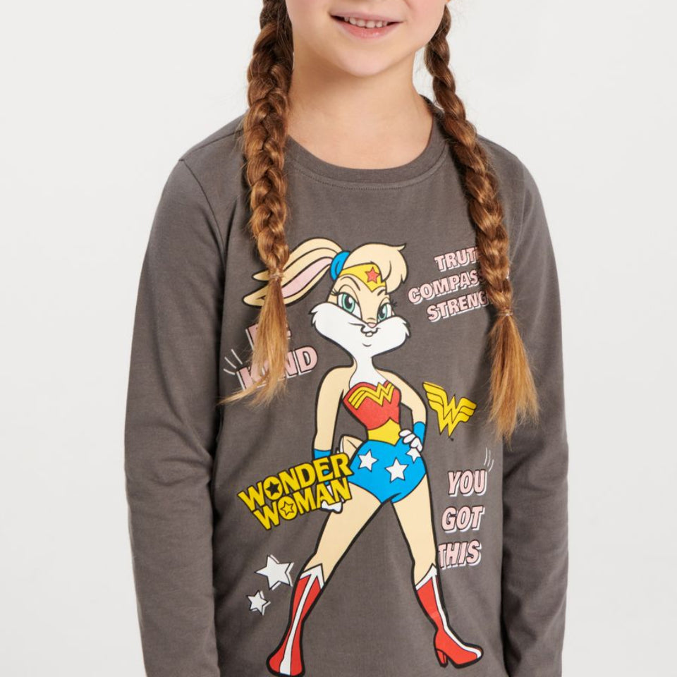 A young girl with braided hair wearing a dark gray long-sleeve t-shirt featuring a graphic of Wonder Woman with the text 'TRUE GOGETHER SENSE!' and 'YOU GOT THIS!'.