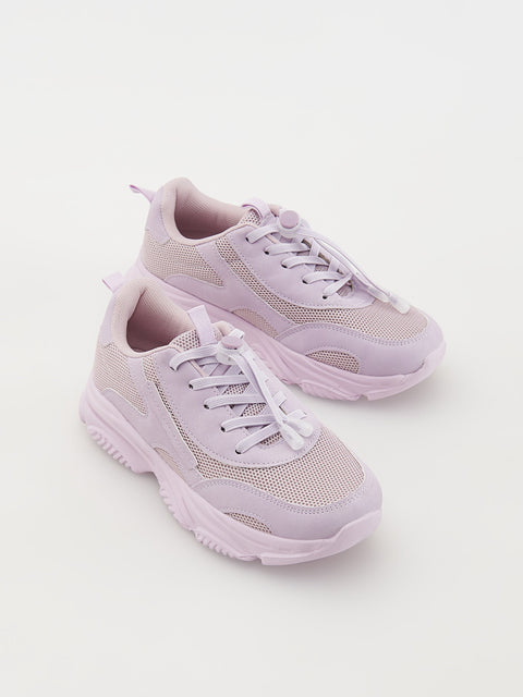Pair of light purple sneakers on a white background