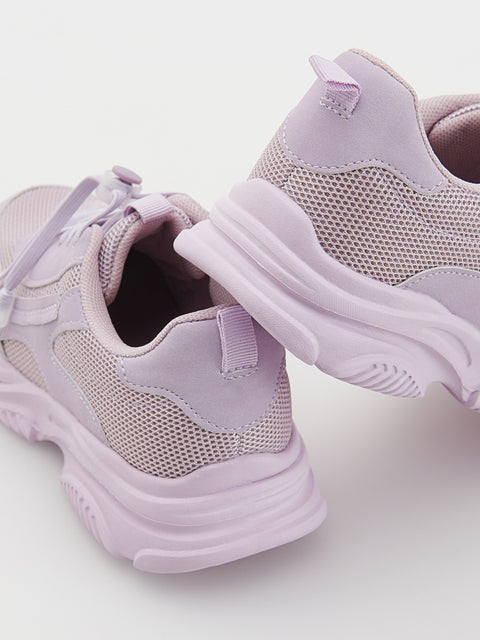 Pair of light purple children's sneakers on a white background