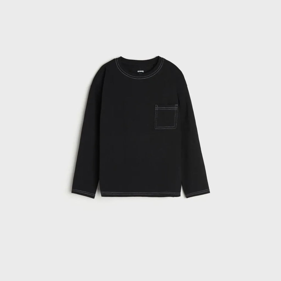 A black long-sleeve crewneck shirt with a single patch pocket on the left chest, featuring contrasting light gray stitching, displayed on a light gray background.