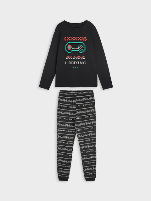 Black long-sleeve top and patterned pants set on a white background