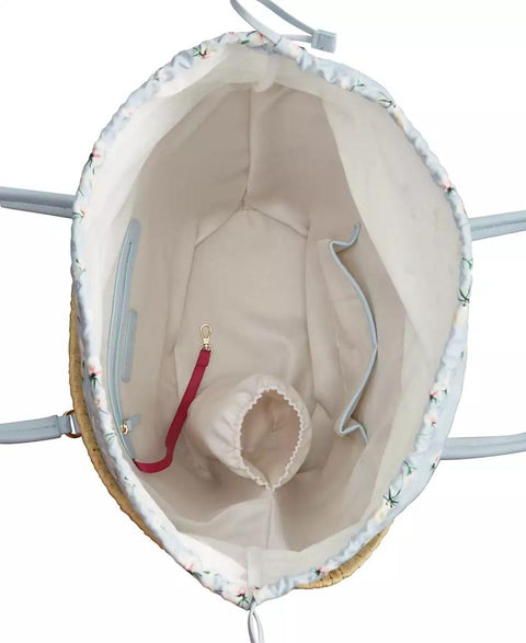 Close-up of a baby carrier with a small baby doll inside, on a white background