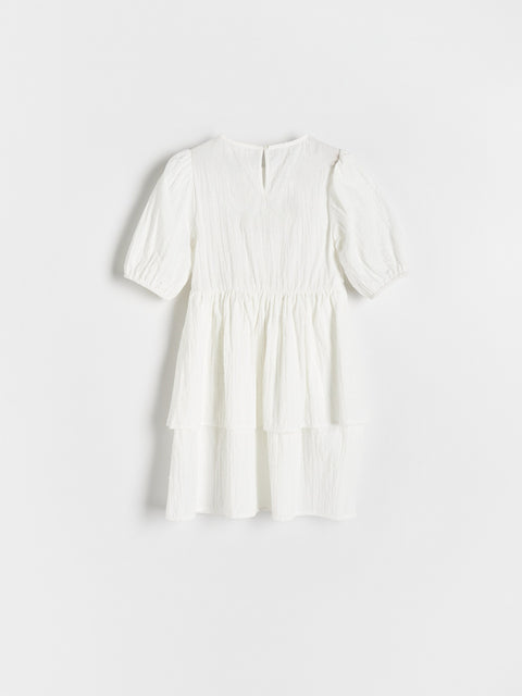 White dress on a light gray background
