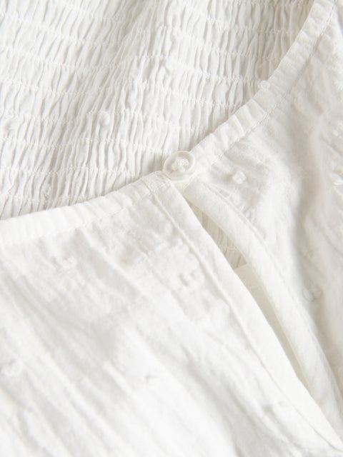 Close-up of white fabric with a textured pattern