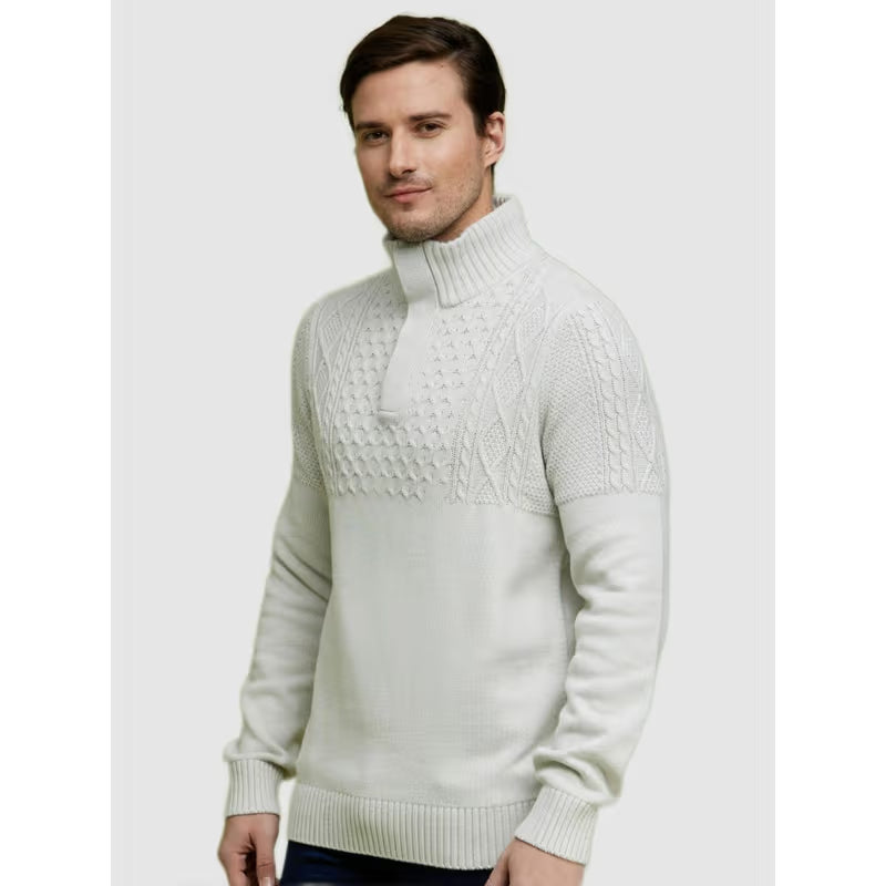 Man wearing a light gray cable knit sweater on a white background