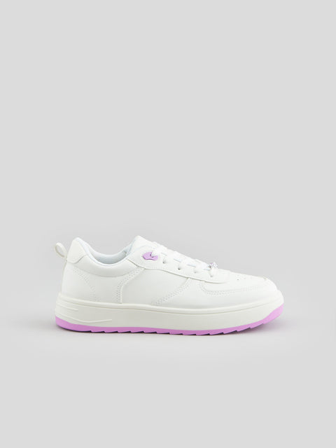 White sneakers with pink soles on a gray background