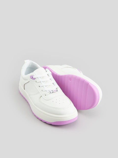 White sneakers with purple soles on a light gray background
