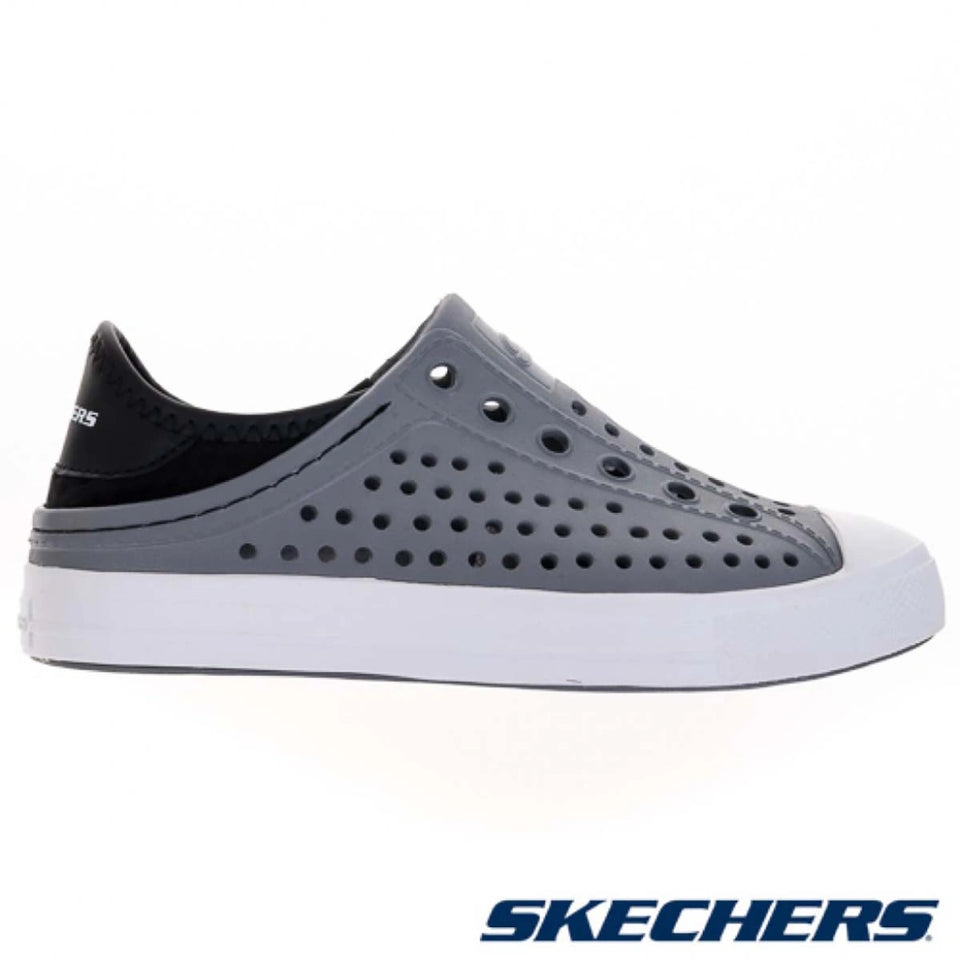 A Skechers slip-on shoe in gray and black with a white sole, shown from a side profile on a white background with the Skechers logo at the bottom right.