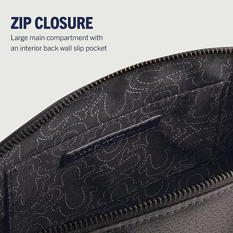 Close-up of a black bag with a zipper closure and interior slip pocket on a light gray background.