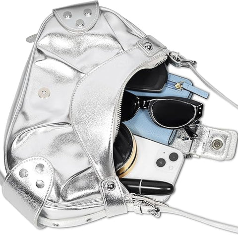 Silver backpack with sunglasses, phone, and other items on a white background