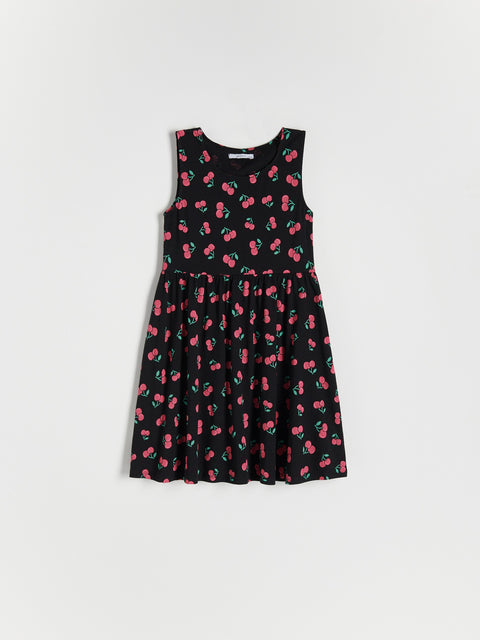 Black dress with pink cherry pattern on a white background