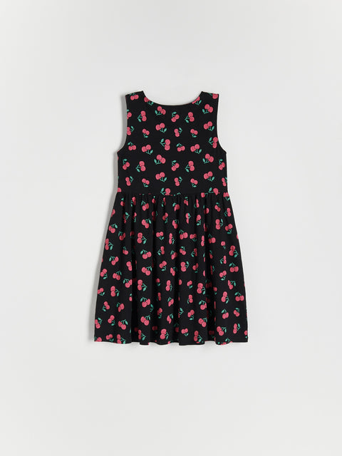 Black dress with pink cherry pattern on a white background
