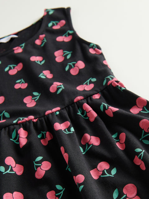 Black dress with pink cherry pattern on a white background