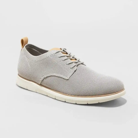 Gray mesh shoe with white sole on a light gray background