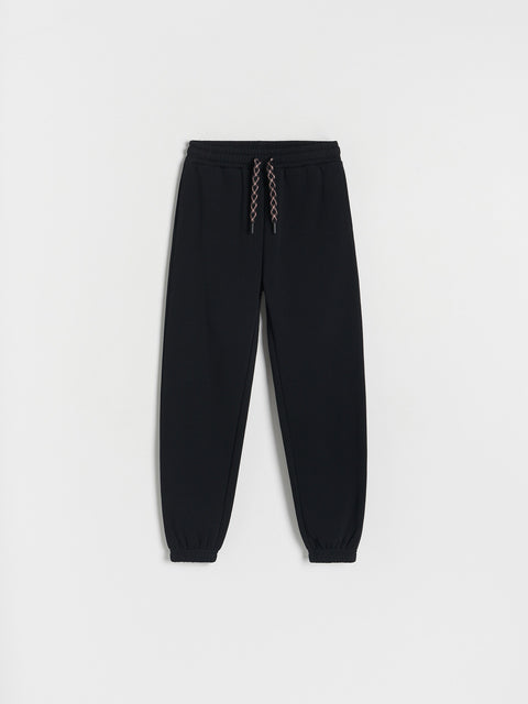 Black jogger pants on a white background
