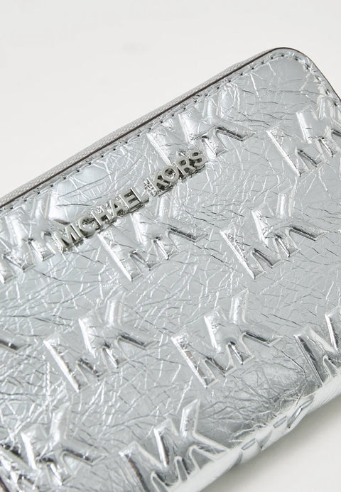 Silver textured wallet with 'Michael Kors' branding on a light gray background