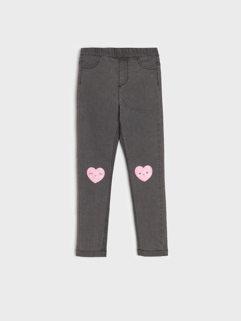 Gray leggings with pink heart designs on a white background