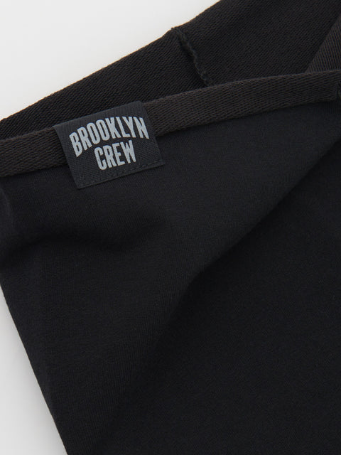 Black pants with a 'Brooklyn Crew' label on a white background