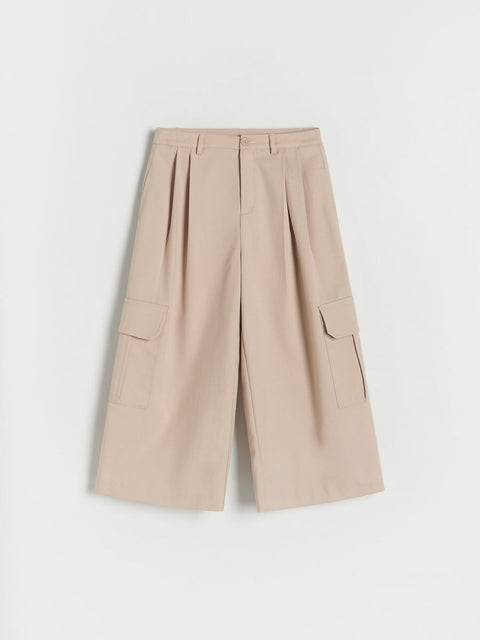 Beige wide-leg pants on a light gray background