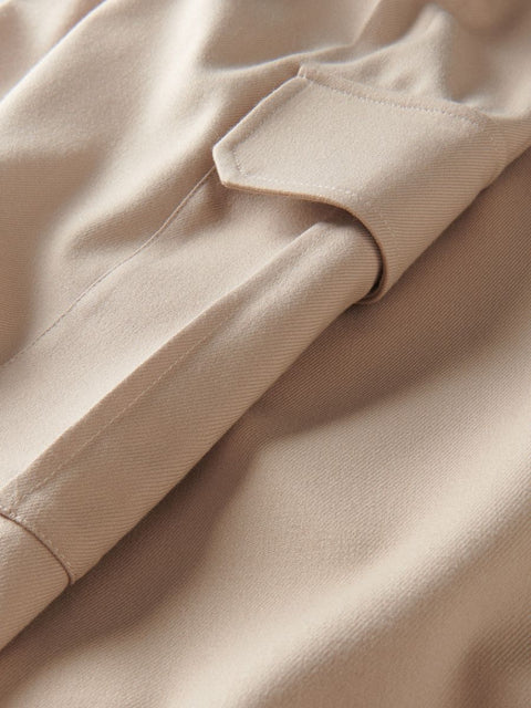 Close-up of beige fabric with a pocket detail