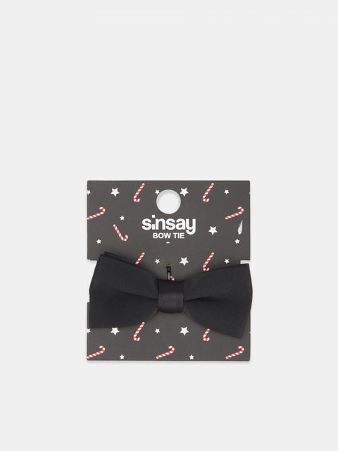 Black bow tie in a decorative packaging with 'sinsay' branding on a white background
