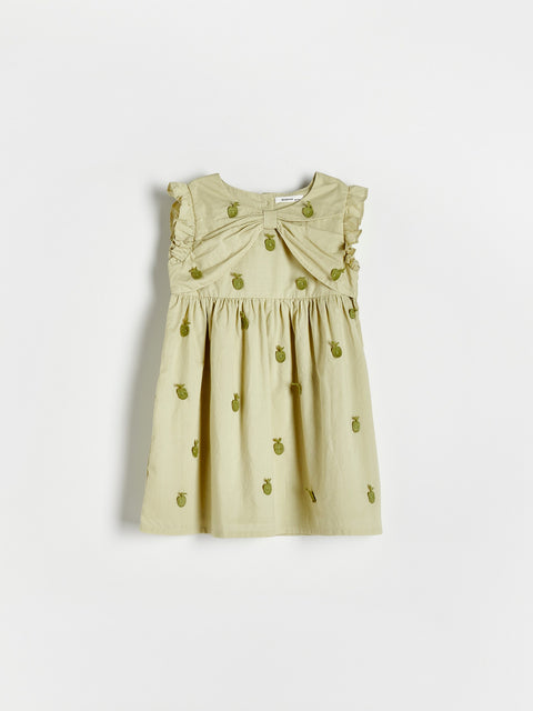 Beige dress with green floral patterns on a white background