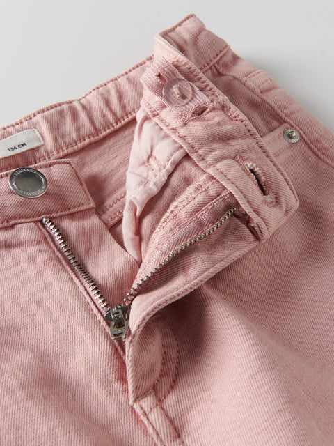 Close-up of pink denim pants with a zipper on a light gray background
