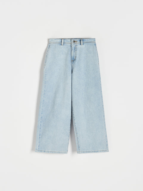 Light blue denim jeans on a white background