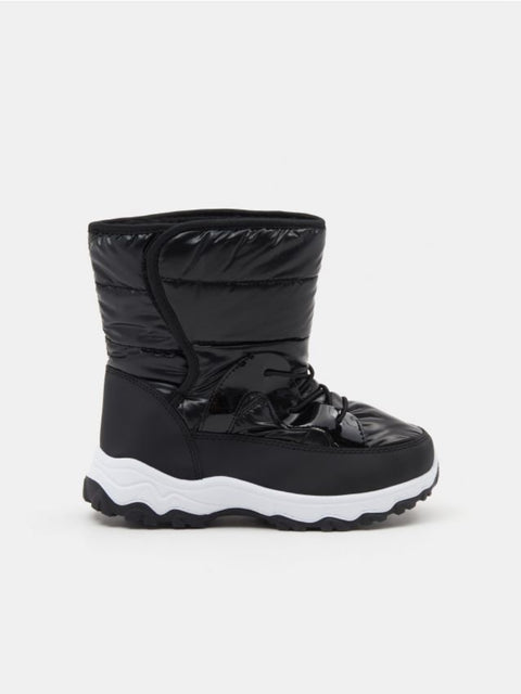 Black winter boot with white sole on a light gray background
