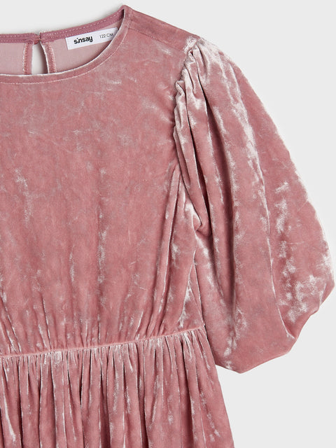 Pink distressed dress with ruffled sleeves on a white background