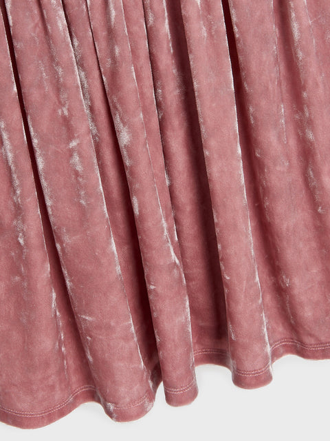 Close-up of a pink pleated fabric with a white background