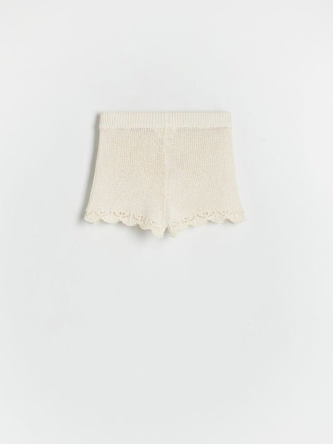 Beige lace-trimmed fabric on a white background