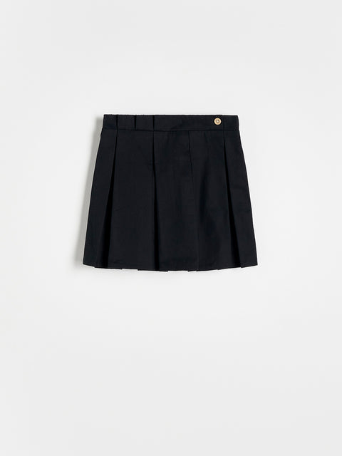 Black pleated skirt on a light gray background