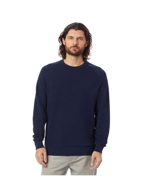 Man wearing a navy blue sweater and beige pants on a white background