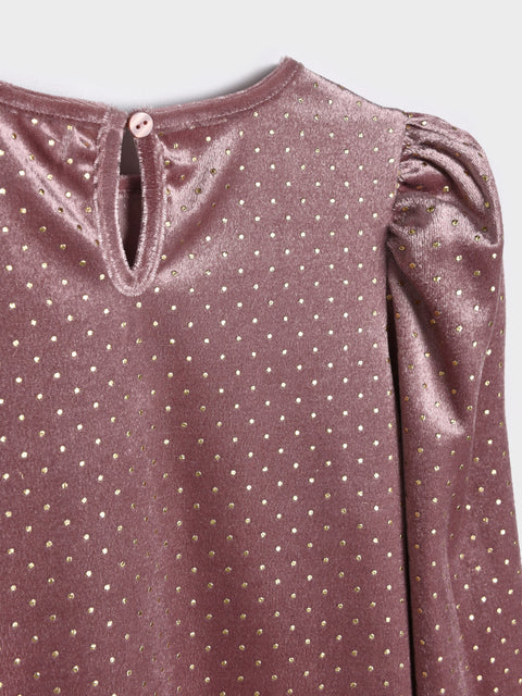 Close-up of a purple blouse with gold polka dots on a light gray background