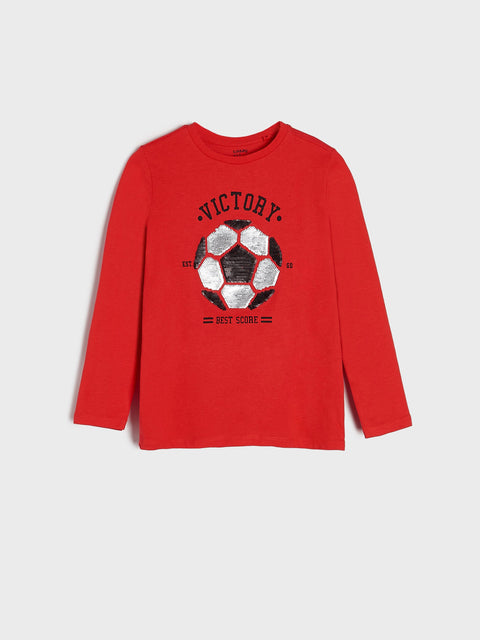 Red long-sleeve shirt with soccer ball graphic and 'Victory' text on a light gray background