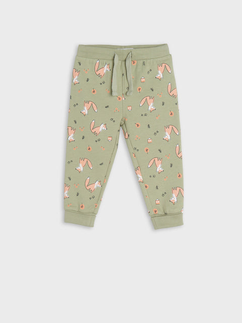 Green children's jogger pants with animal pattern on a white background