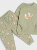 Children's green pajama set with fox patterns on a white background