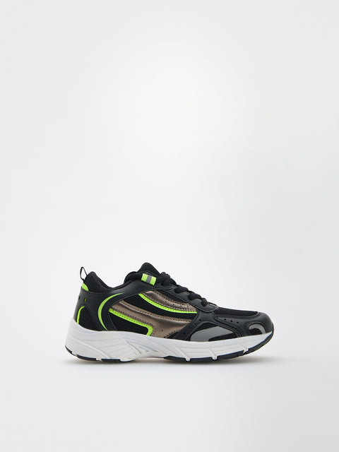 Black and green athletic shoe on a white background