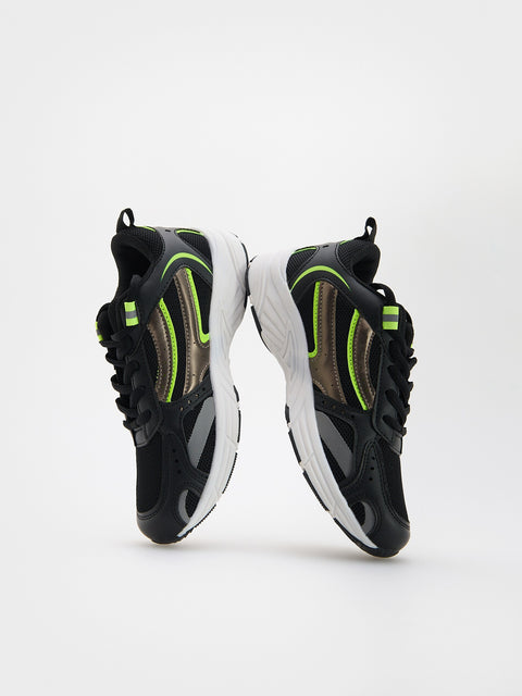 Black and green sneakers on a white background