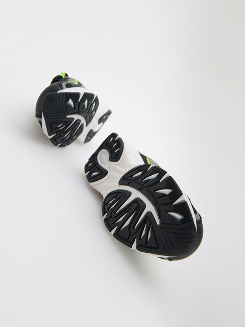 Black and white sports cleats on a light gray background